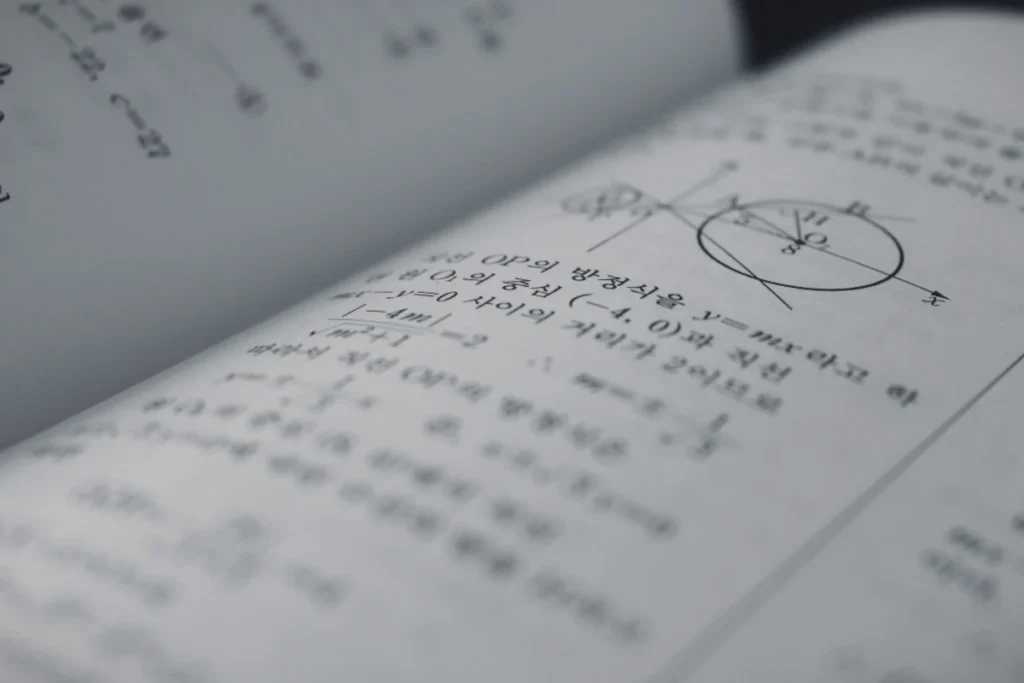 Book with numerology calculations and writings on its pages.